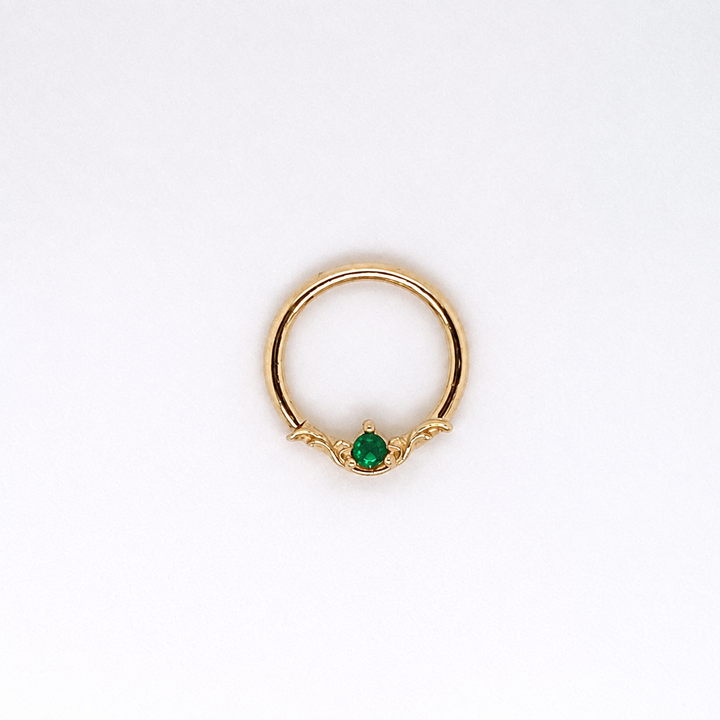 AuAdore Bishop Lab Emerald ring in 14k yellow gold with a green round gemstone and ornate filigree on a white background.