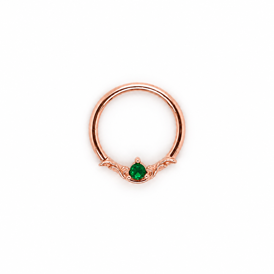 AuAdore Bishop Lab Emerald ring in 14k rose gold with a green round gemstone and matching rose-gold prongs and filigree on white.