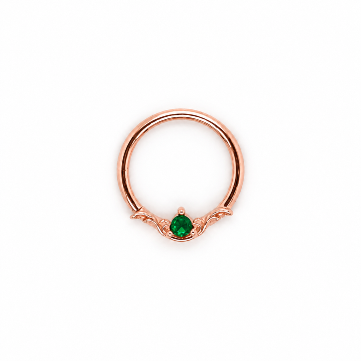 AuAdore Bishop Lab Emerald ring in 14k rose gold with a green round gemstone and matching rose-gold prongs and filigree on white.