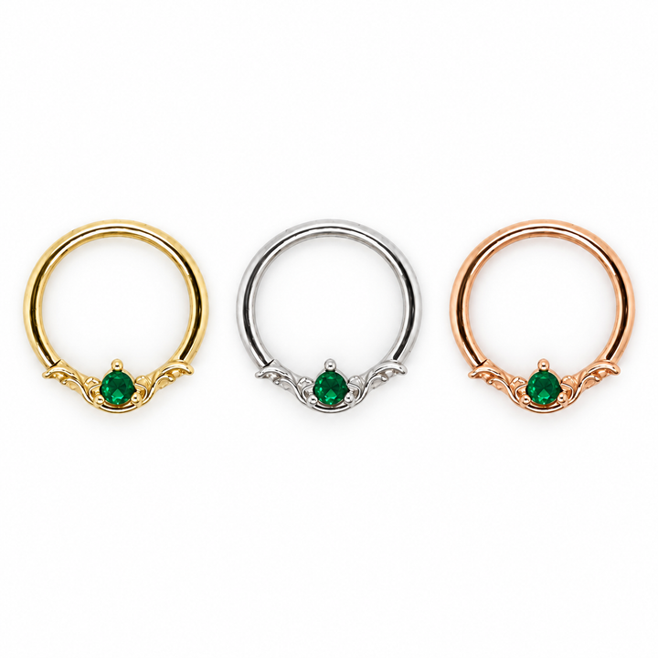 AuAdore Bishop Lab Emerald rings shown left to right in yellow gold, white gold, and rose gold, each with a green round gemstone and matching metal settings.