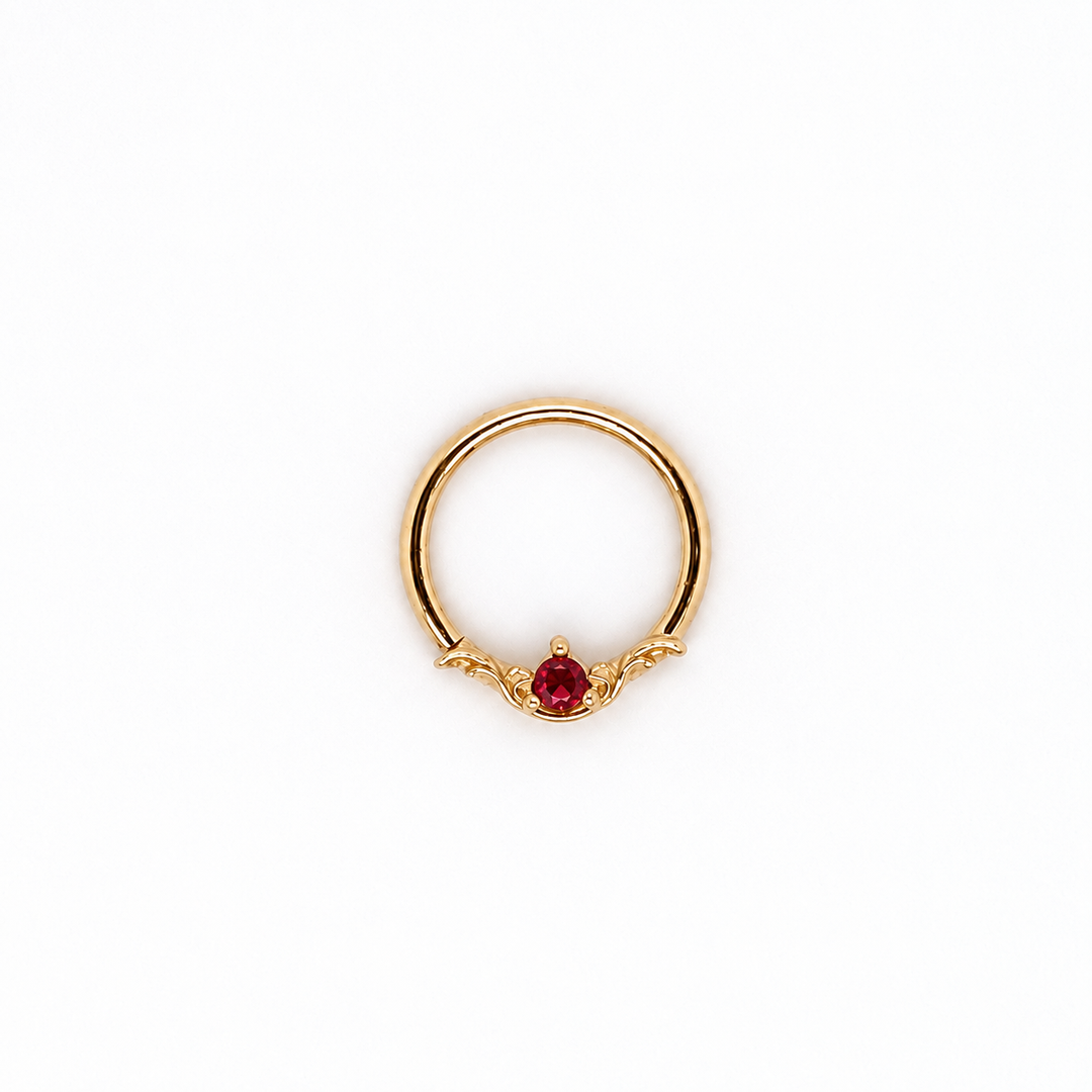 AuAdore Bishop Lab Ruby ring in 14k yellow gold with a red round gemstone and ornate filigree on a white background.