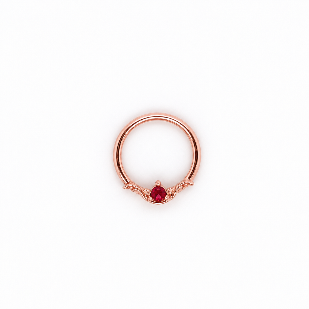 AuAdore Bishop Lab Ruby ring in 14k rose gold with a red round gemstone and matching rose-gold prongs and filigree on white.
