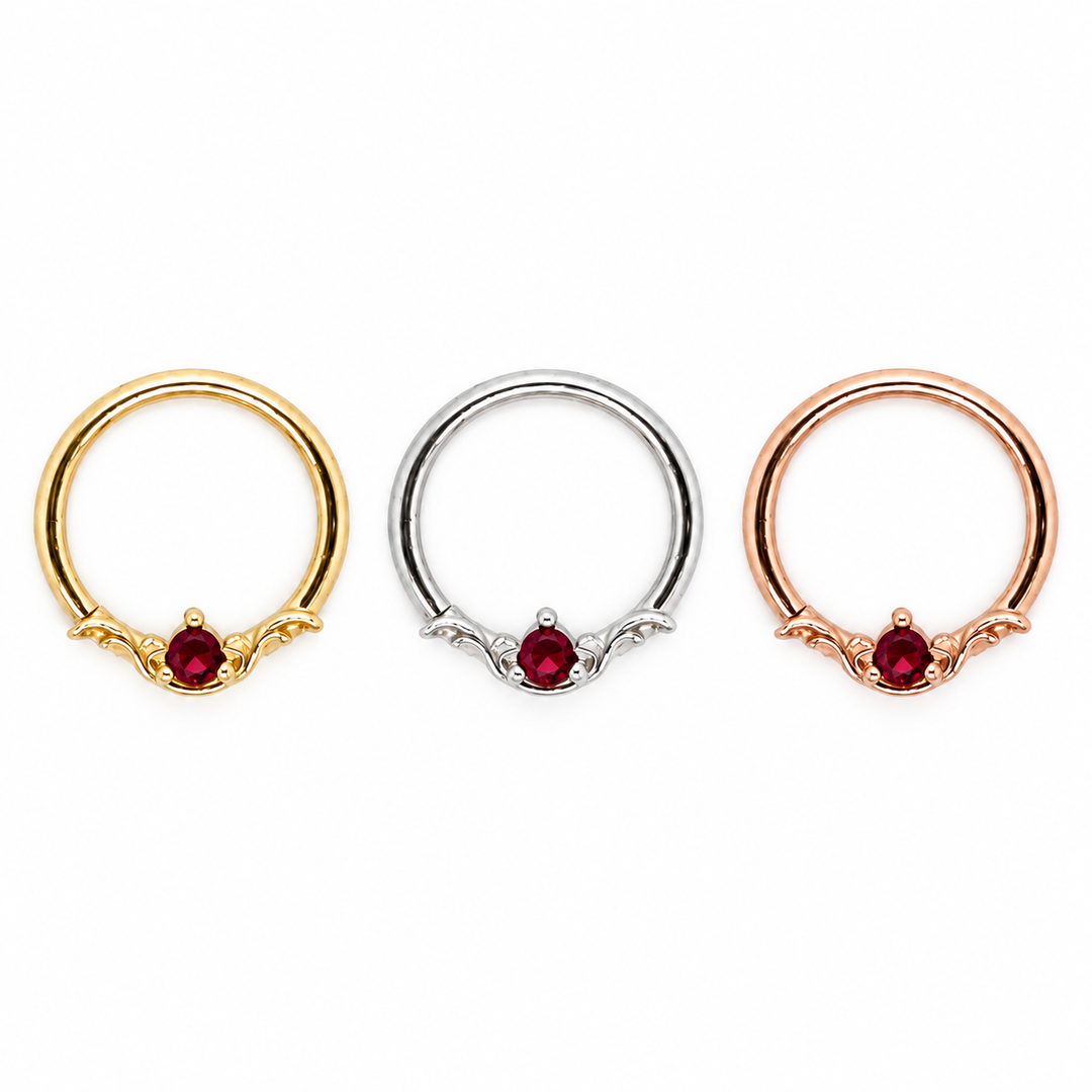 AuAdore Bishop Lab Ruby rings shown left to right in yellow gold, white gold, and rose gold, each with a red round gemstone and matching metal settings.