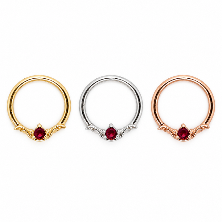 AuAdore Bishop Lab Ruby rings shown left to right in yellow gold, white gold, and rose gold, each with a red round gemstone and matching metal settings.