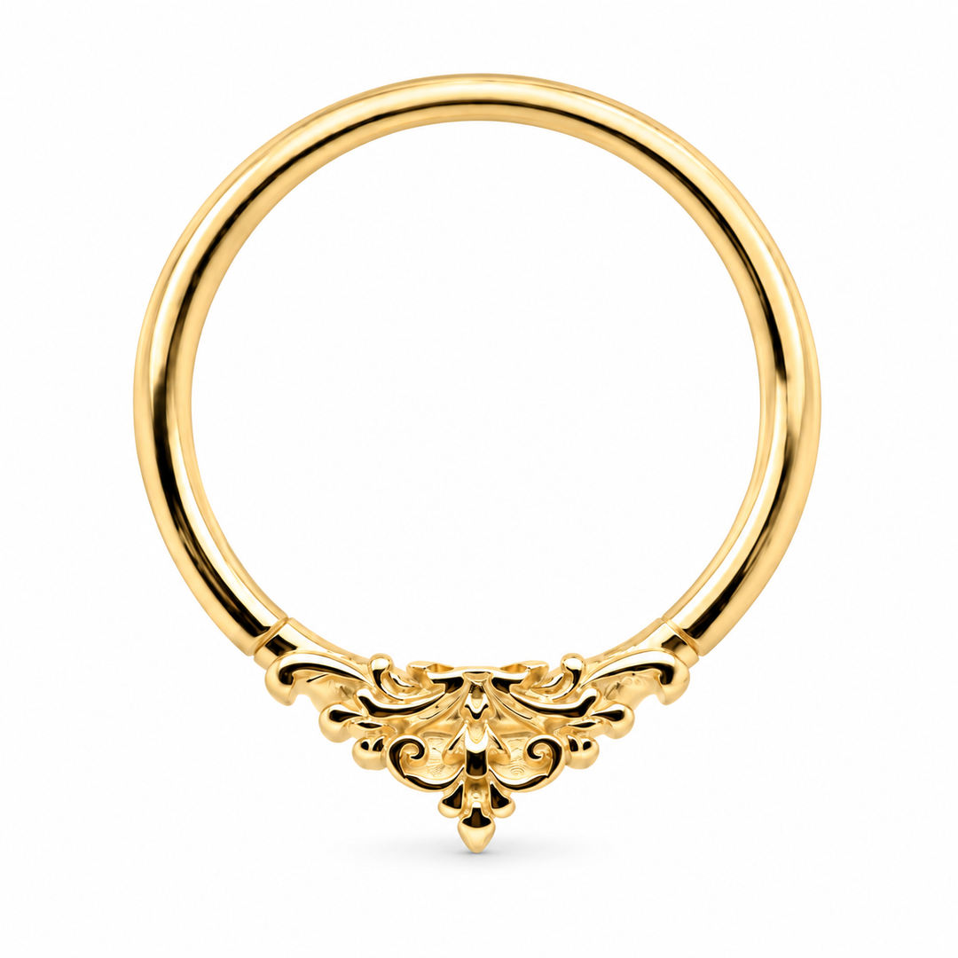AuAdore Florentine ring in 14k yellow gold, with a smooth hoop top and ornate filigree, centered on white.