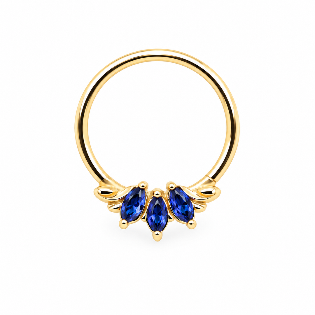 AuAdore Grandeur Lab Blue Sapphire ring in 14k yellow gold, with three blue marquise gemstones, delicate side flourishes and a smooth hoop top on white.