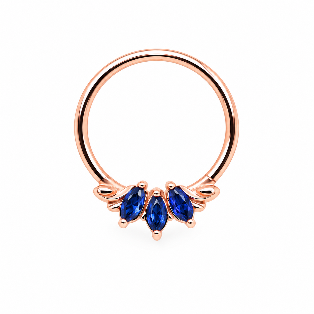 AuAdore Grandeur Lab Blue Sapphire ring in 14k rose gold, with three blue marquise gemstones, matching rose-gold prongs and delicate side flourishes on white.