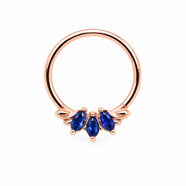 AuAdore Grandeur Lab Blue Sapphire ring in 14k rose gold, with three blue marquise gemstones, matching rose-gold prongs and delicate side flourishes on white.