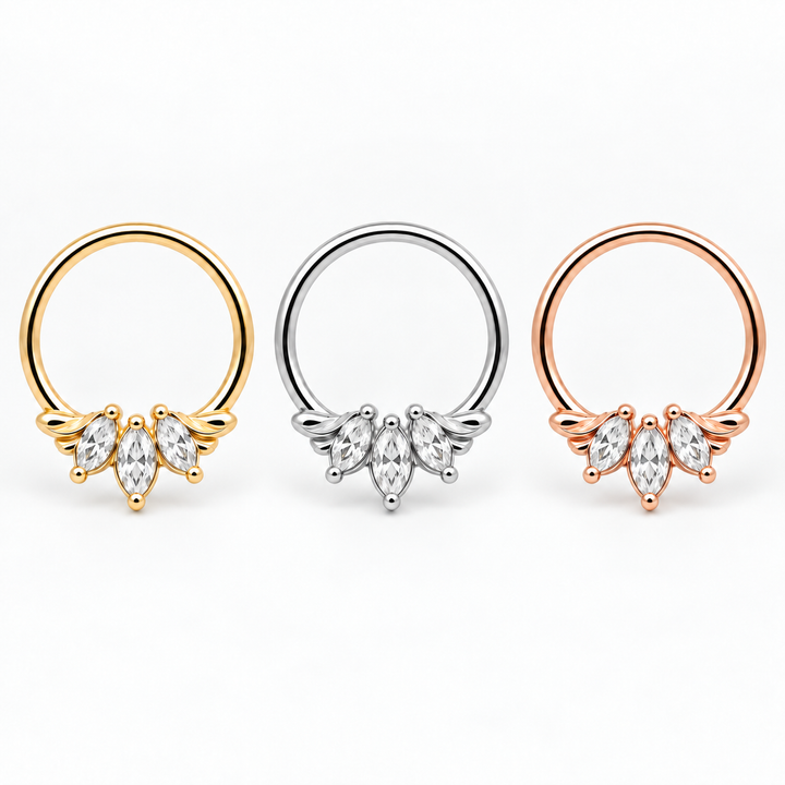 AuAdore Grandeur Lab Diamond rings in yellow gold, white gold and rose gold from left to right, each with three clear marquise gemstones and smooth hoop tops on white.