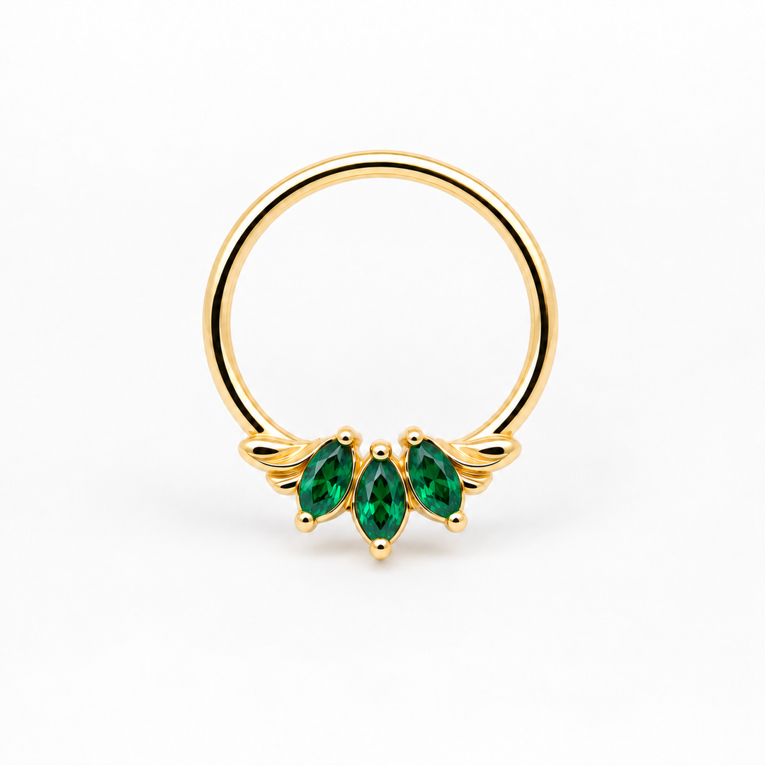 AuAdore Grandeur Lab Emerald ring in 14k yellow gold, with three green marquise gemstones, delicate side flourishes and a smooth hoop top on white.