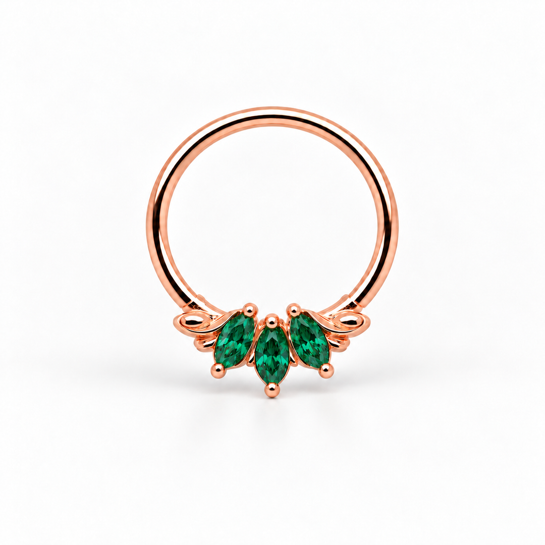 AuAdore Grandeur Lab Emerald ring in 14k rose gold, with three green marquise gemstones, matching rose-gold prongs and a smooth hoop top on white.