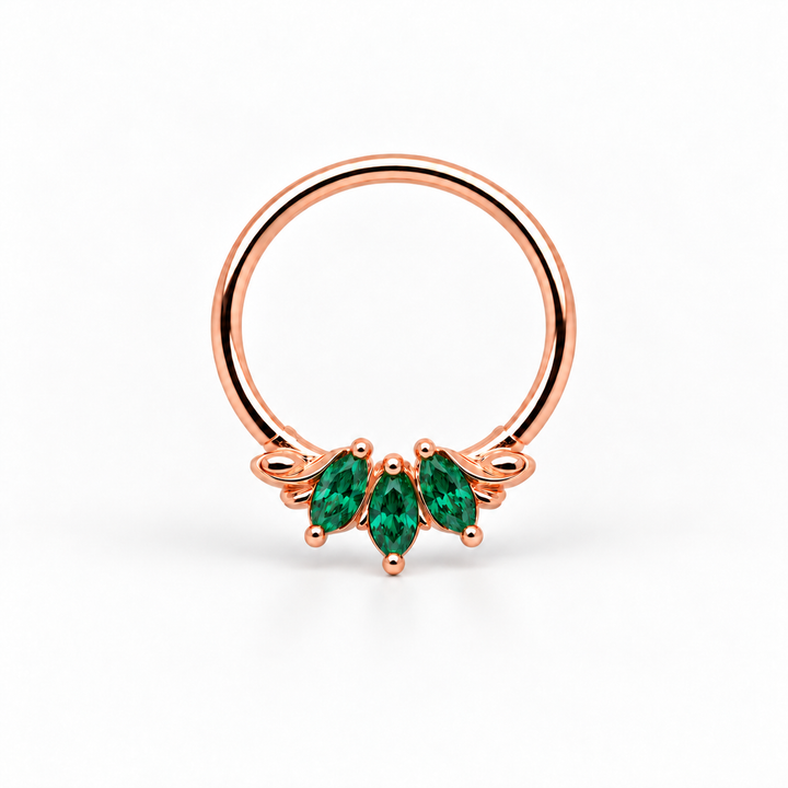 AuAdore Grandeur Lab Emerald ring in 14k rose gold, with three green marquise gemstones, matching rose-gold prongs and a smooth hoop top on white.