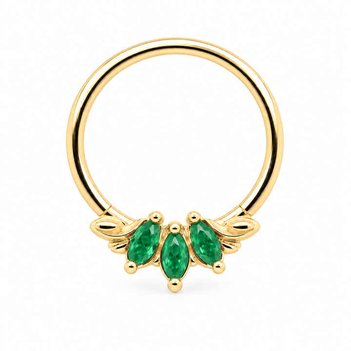 AuAdore Grandeur Natural Emerald piercing ring in 14k yellow gold with three marquise green gemstones, delicate side filigree and a smooth hoop top on white.