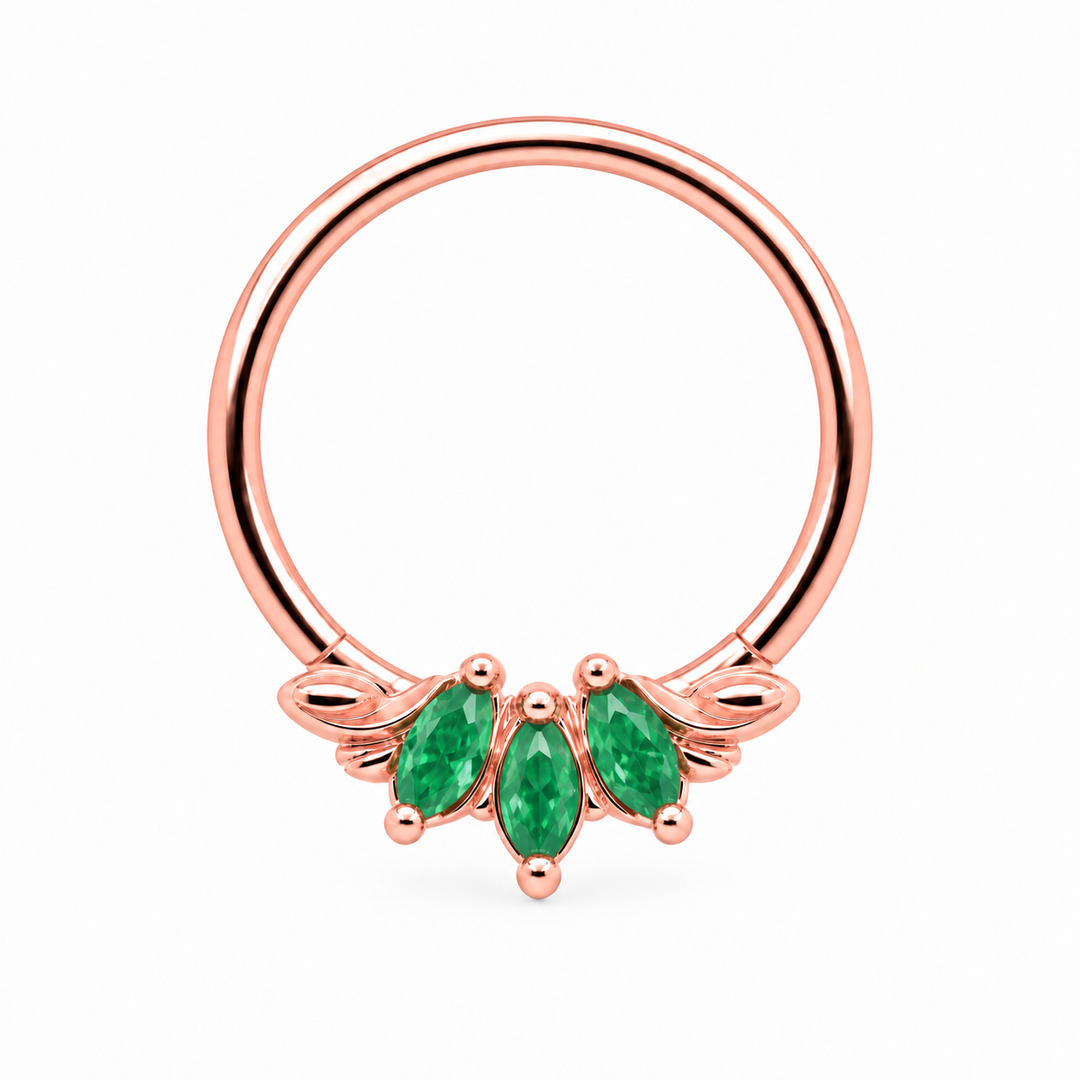 AuAdore Grandeur Natural Emerald piercing ring in 14k rose gold with three marquise green gemstones, matching rose-gold prongs and side filigree and a smooth hoop top on white.