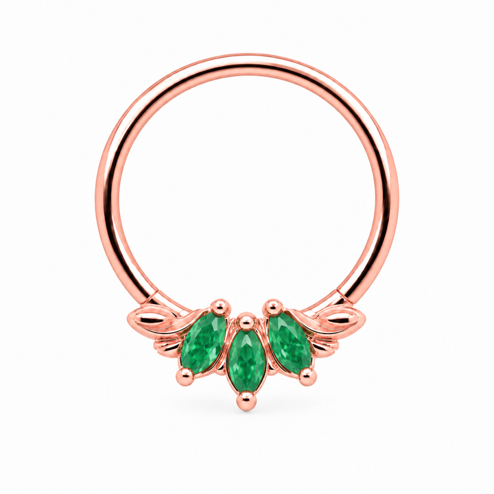AuAdore Grandeur Natural Emerald piercing ring in 14k rose gold with three marquise green gemstones, matching rose-gold prongs and side filigree and a smooth hoop top on white.