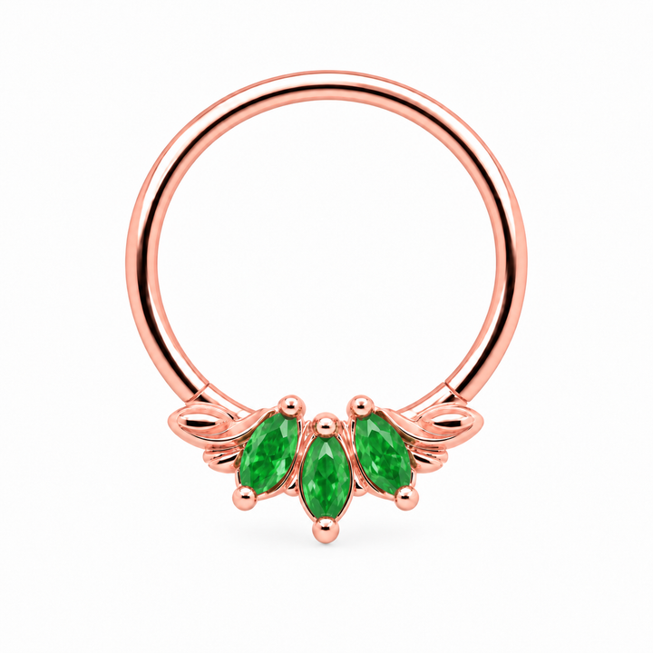 AuAdore Grandeur Tsavorite 16g piercing ring in 14k rose gold with three green marquise gemstones and matching prongs and filigree. Digital color illustration.