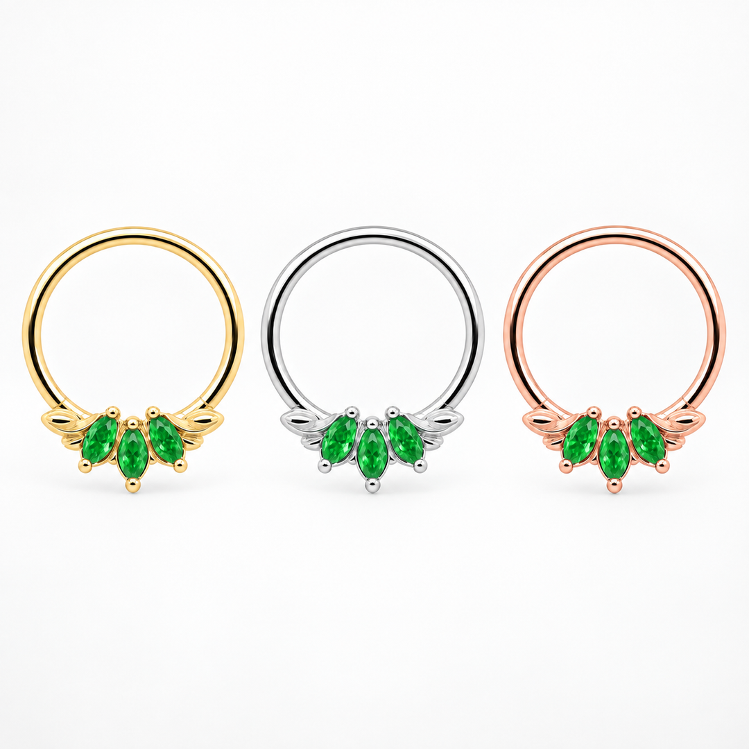 AuAdore Grandeur Tsavorite piercing rings in one horizontal row, yellow gold, white gold, and rose gold from left to right. Digital color illustration.