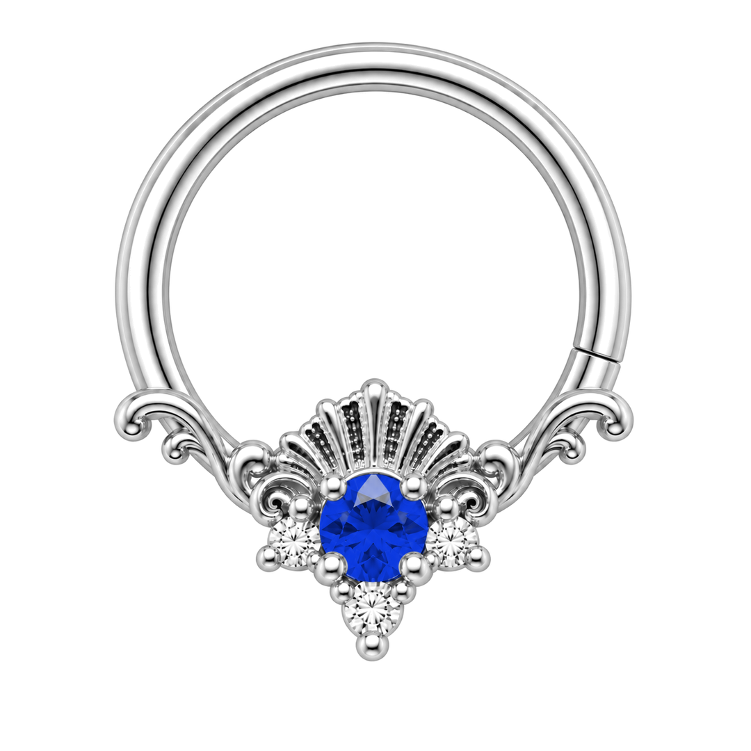 AuAdore Lennox Lab Blue Sapphire and Diamond 16g ring in white gold, including matching white-gold prongs and filigree. Blue center, three clear accents and one lower-right seam. Digital color illustration.