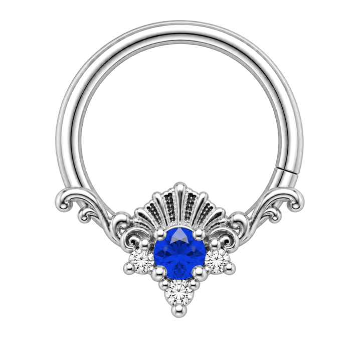 AuAdore Lennox Lab Blue Sapphire and Diamond 16g ring in white gold, including matching white-gold prongs and filigree. Blue center, three clear accents and one lower-right seam. Digital color illustration.